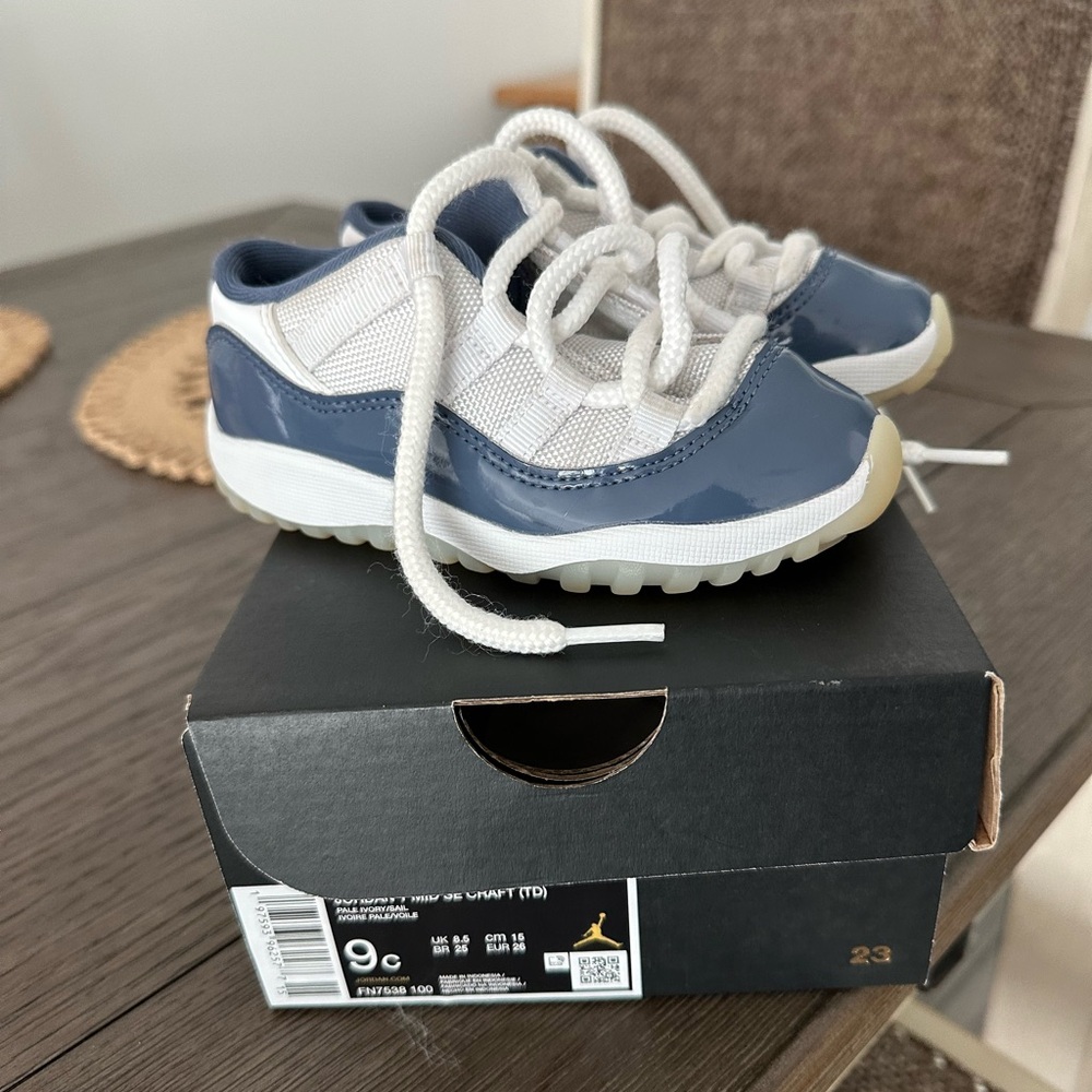 Jordan 11’s Blue/White Sneakers w/ Low-Top Design and Lace-Up Closure.